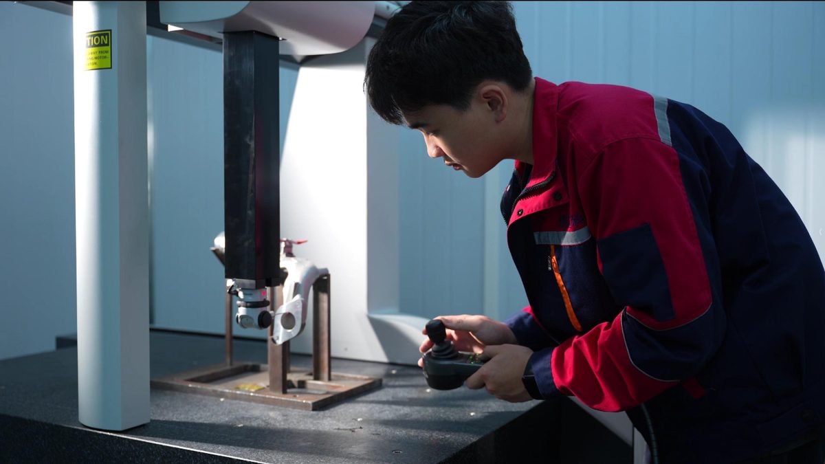 Quality inspector operating CMM coordinate measuring machine